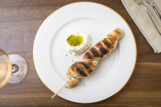 Stockbrot (bread on a stick) served with creme fraiche and pumpkin seed oil.