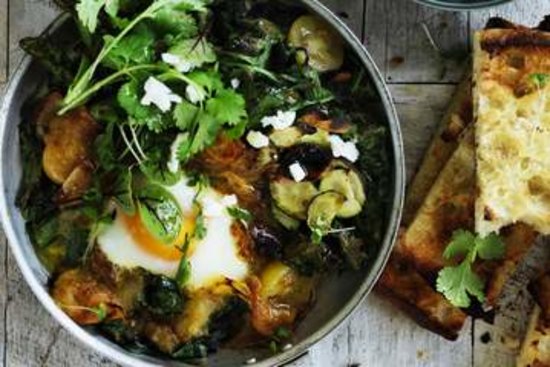 Green shakshuka with hummus and Turkish bread.