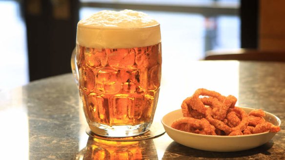 A pint of Reschs beer with pork crackling.