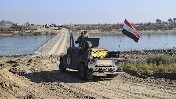 Iraqi forces cross a bridge over the Euphrates supplied by the US Army Corps of Engineers on the approach to Ramadi. Islamic State destroyed the existing bridges across the river as a defensive measure.