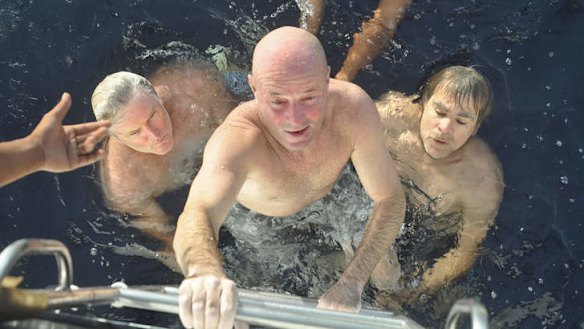 Saved: Brett Archibald climbs to safety watched by Simon Carlin (left) and Colin Chenu (right).
