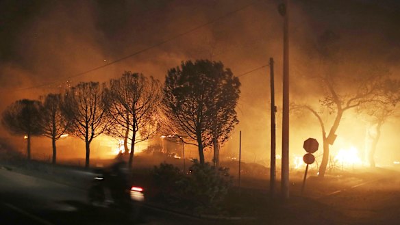 Buildings burn in the town of Mati.