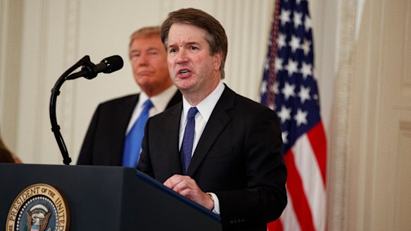 US President Donald Trump listens as Brett Kavanaugh, his Supreme Court nominee, speaks during an event in the East Room of the White House, Monday.