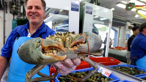 Impress with something different this Christmas ... Con Doukas from Musumeci Seafoods holds up a large mud crab from North Queensland.