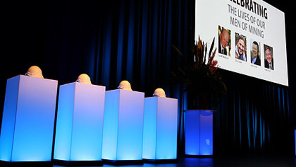 Four miner's helmets adorn the stage during the memorial for the Sundance plane crash victims.