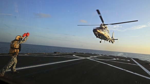 A Dolphin Z-9 helicopter of China's Navy missile frigate CNS Yulin flies off the deck of Singapore's Navy missile frigate RSS Intrepid in the South China Sea on May 25.