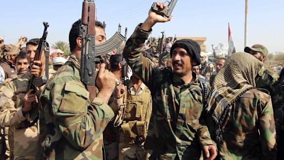 Iraqi security forces and Shiite fighters gather at Udhaim dam, north of Baghdad.
