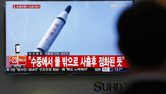 A South Korean man watches TV news footage of a missile launch conducted by North Korea in April.