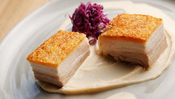 Properly crisp pork belly with white bean puree and red cabbage.