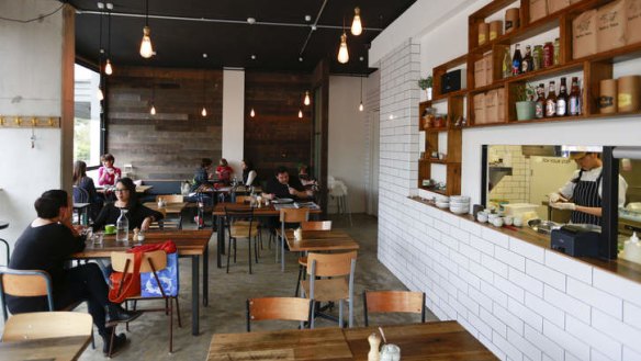 The Baba Sus interior features white-tiled walls and timber highlights.