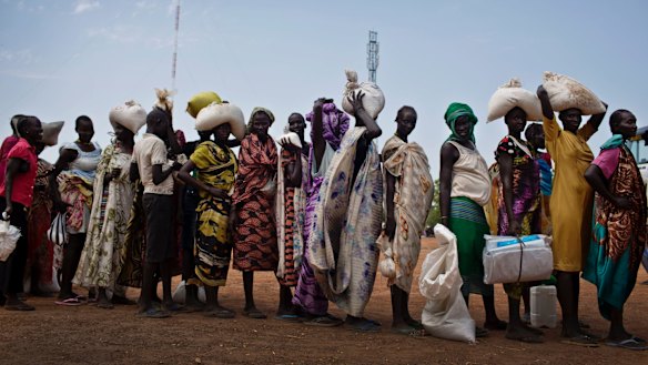 Women who fled fighting in nearby Leer in recent months, queue for food aid at a food distribution made by the World Food Programme in Bentiu, South Sudan. 