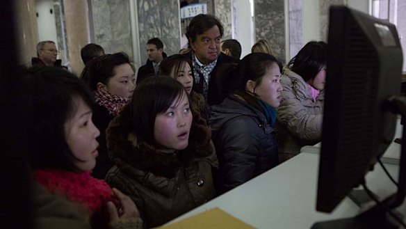 Bill Richardson watches North Koreans working on computers at the Grand Peoples Study House in Pyongyang.
