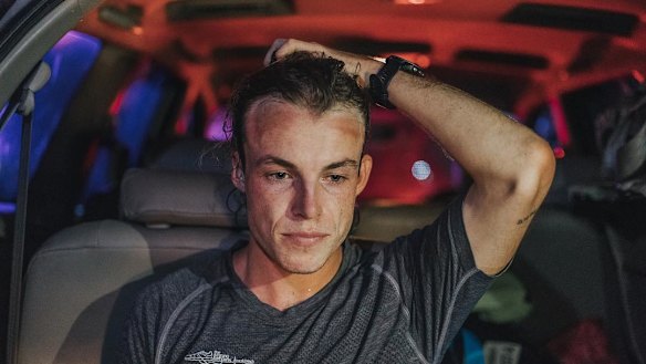 Josh Lynott sits in a support car at the end, exhausted by his effort.