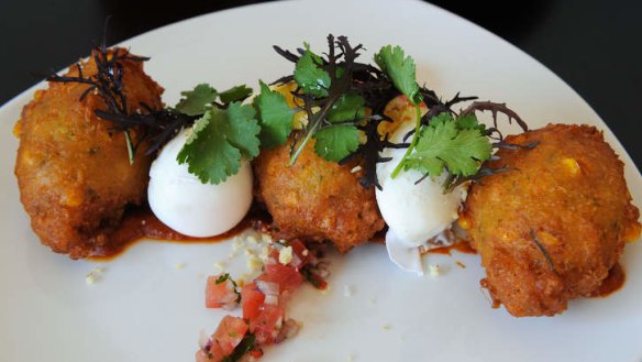 Corn fritters with kasoundi and poached eggs.