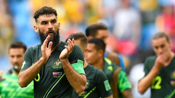 Honours even: Mile Jedinak applauds the crowd after the final whistle.