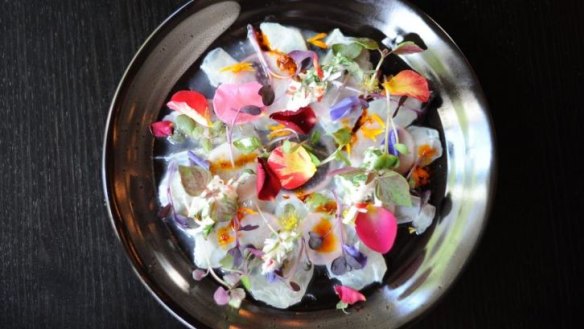 Blue-eye ceviche with young coconut, nuoc cham, finger lime, edible flowers and microherbs.