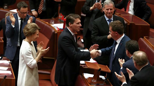 Senator James McGrath is congratulated by Senator Cory Bernardi after delivering his first speech. Photo: Alex Ellinghausen
