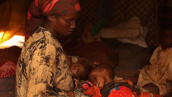 Distressing ... Yaray Bule Ibrahim gazes on her seriously ill daughter Farahiya, 2, as she nurses four-month-old Fardosa in a Kenyan refugee camp.