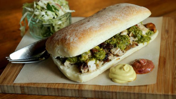 Porchetta sandwich with a side of slaw.