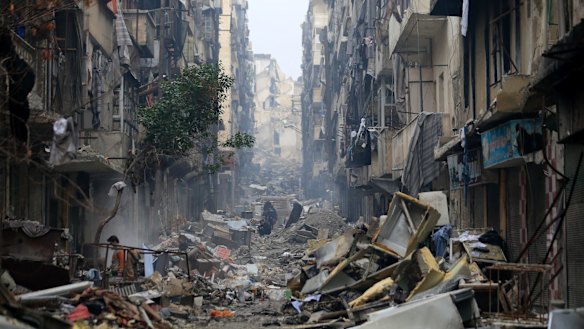 Residents walk through the destruction of the once rebel-held Salaheddine neighbourhood in eastern Aleppo, Syria. 