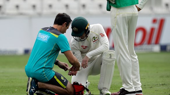 Australian captain Tim Paine receives treatment. 