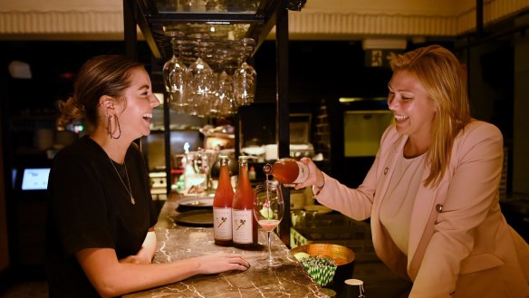 Naomi Rheinberger (left) has a glass of Cullen Rose Moon sparkling poured for by QT Sydney sommelier Samantha Belt. Australian sparkling sales have increased since the COVID-19 pandemic.