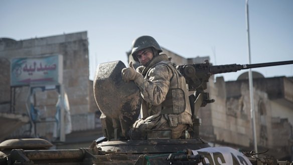 A Turkish soldier on a tank is pictured in the northern Syrian town of Kobane as he returns from a military operation inside Syria.