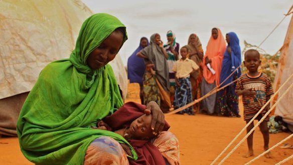 Lucky break ... Somalia refugee Ladhan Waraq lost one of her children to famine, but five-month-old Sahlan was given life-saving treatment after she was discovered by the Herald.