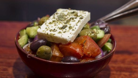 A classic Greek salad with a big sheet of salty feta.