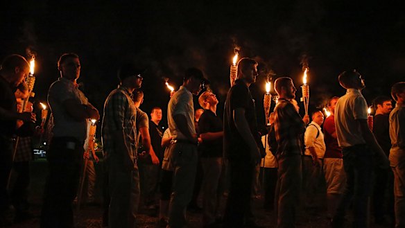 White nationalist groups march through the University of Virginia campus in Charlottesville on Friday.