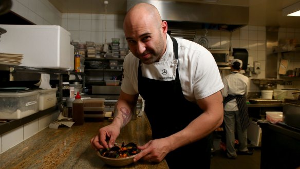 Shane Delia plating the poached mussels with saffron and moghrabieh couscous served at his restaurant Maha.