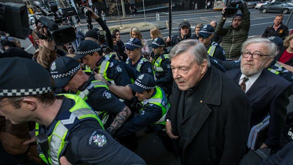 Cardinal George Pell and Robert Richter arrive at Melbourne Magistrates' Court in July 2017.