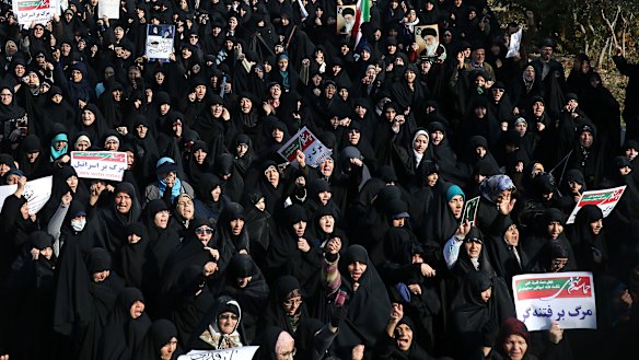 Iranian protesters chant slogans at a rally in Tehran, Iran.