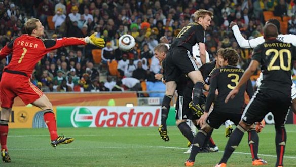 Close shave . . . Germany's goalkeeper Manuel Neuer tries to catch the ball as German players block the Ghanain attackers.