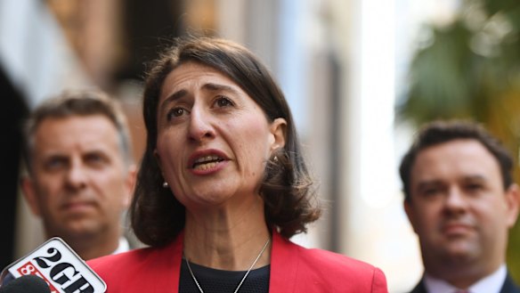 Premier Gladys Berejiklian is flanked by Stuart Ayres and  Andrew Constance while announcing the change in policy on Thursday. 