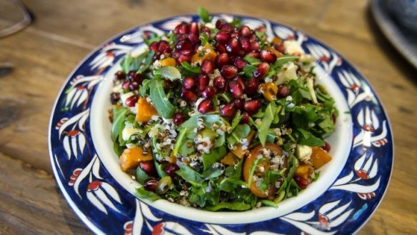 Pomegranate seeds top the quinoa salad.