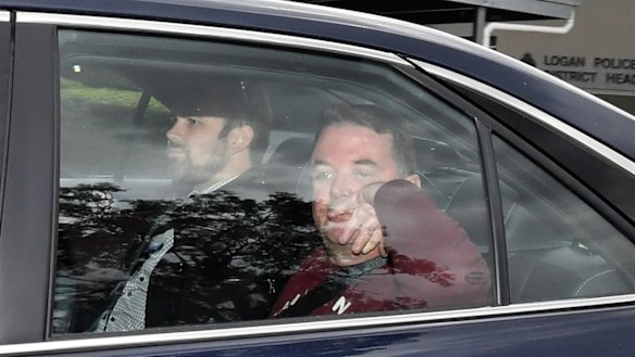 Suspended Logan City mayor Luke Smith (right) leaves Logan Police Headquarters after his arrest.