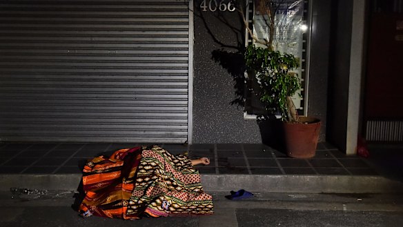 One of two people killed in a double shooting in the Manila suburb of Baclaran, near the airport, lies in the street.