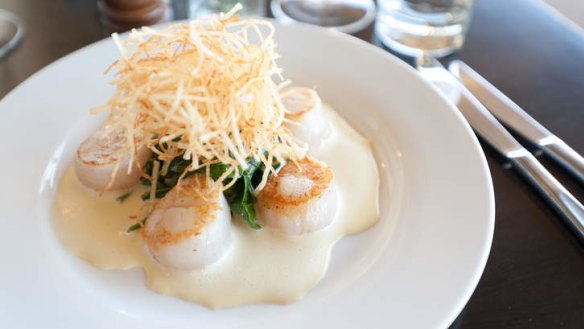 Seared scallops with spinach and shoe-string potatoes.