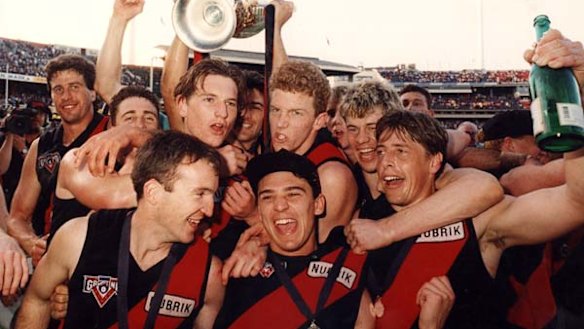 James Hird (fourth from right) and Mark Thompson, right celebrate winning the 1993 grand final with Essendon.