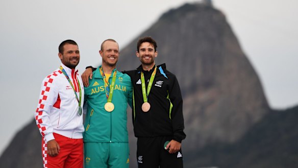 RIO DE JANEIRO, BRAZIL - AUGUST 16:  (L-R) Silver medalist Tonci Stipanovic of Croatia, gold medalist Tom Burton of Australia and bronze medalist Sam Meech of New Zealand celebrate on the podium for the Men's Laser class on Day 11 of the Rio 2016 Olympic Games at the Marina da Gloria on August 16, 2016 in Rio de Janeiro, Brazil.  (Photo by Laurence Griffiths/Getty Images)