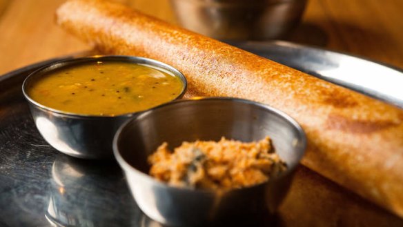 Dosa 'pancake' filled with potato curry, and served with dahl and fresh-coconut chutney.
