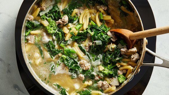 One-pot pasta in progress, with sausage chunks and broccolini.