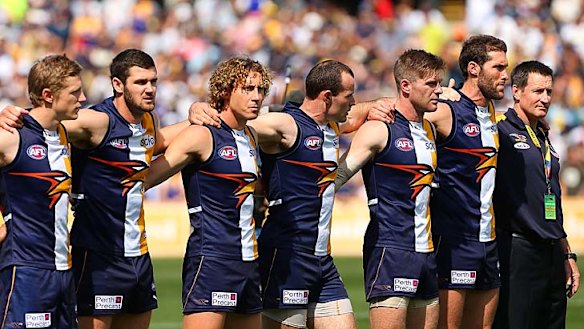 Eagles coach John Worsfold (extreme right) lines up with his players for the national anthem before the elimination final against North Melbourne.