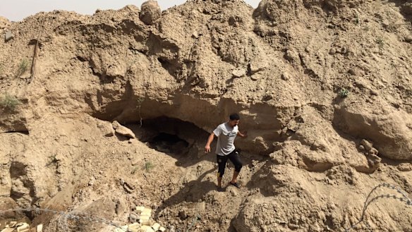 A soldier with Iraq's elite counter-terrorism force last week stands at the mouth of a tunnel dug by Islamic State militants under Fallujah. 