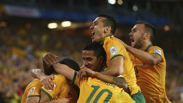 Tim Cahill,  Jason Davidson and Ivan Franjic of Australia celebrate after Massimo Luongo of Australia scored.