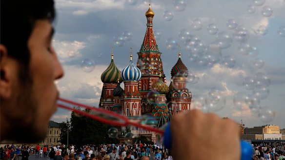 A young man blows bubbles in Red Square during the 2018 soccer World Cup in Moscow.