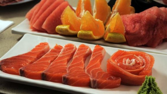An entree of salmon sashimi and fresh fruit at Hot Pot.