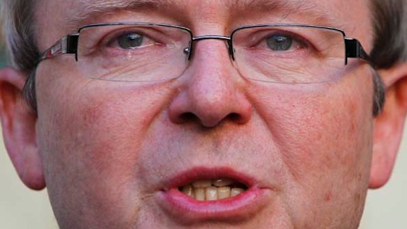 Outgoing Prime Minister Kevin Rudd fights tears as he speaks to journalists.