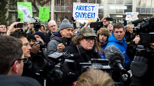Filmmaker Michael Moore, who was born in Flint,  attends a rally outside City Hall, accusing Michigan Governor Rick Snyder of poisoning the city's water.